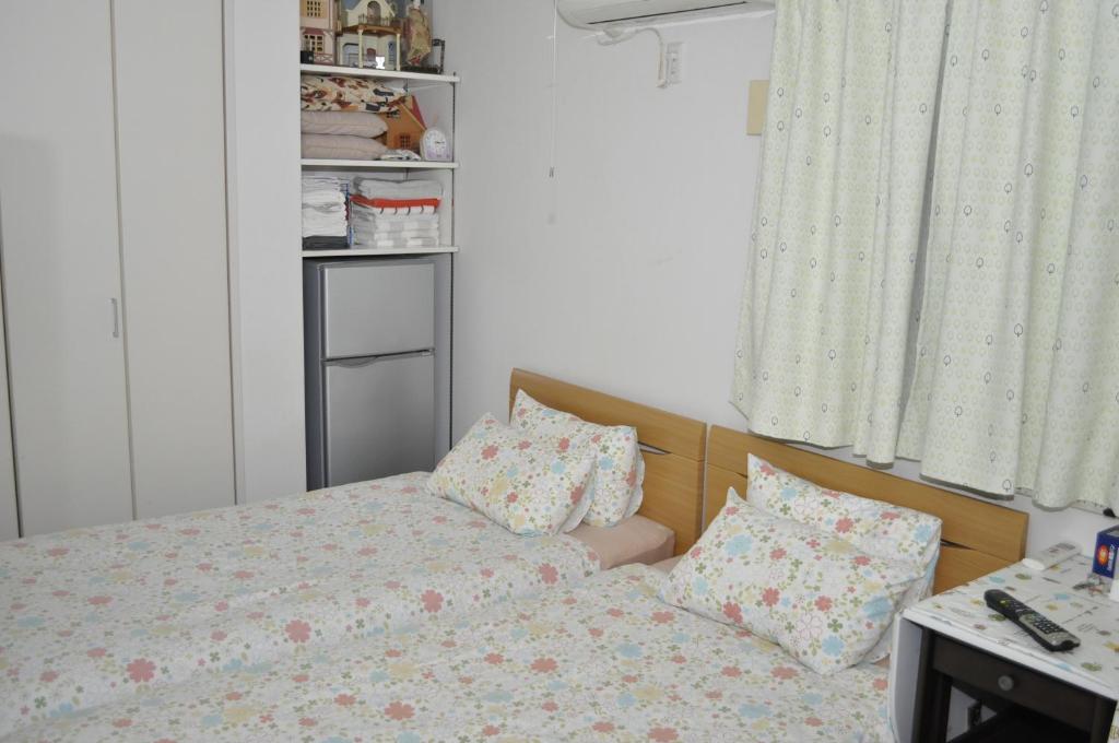 a bedroom with a bed and pillows on it at Sunny moe oo in Tokyo
