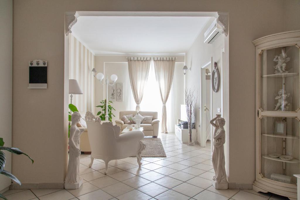 a living room with white furniture and a white couch at La Maison Des Anges in La Spezia