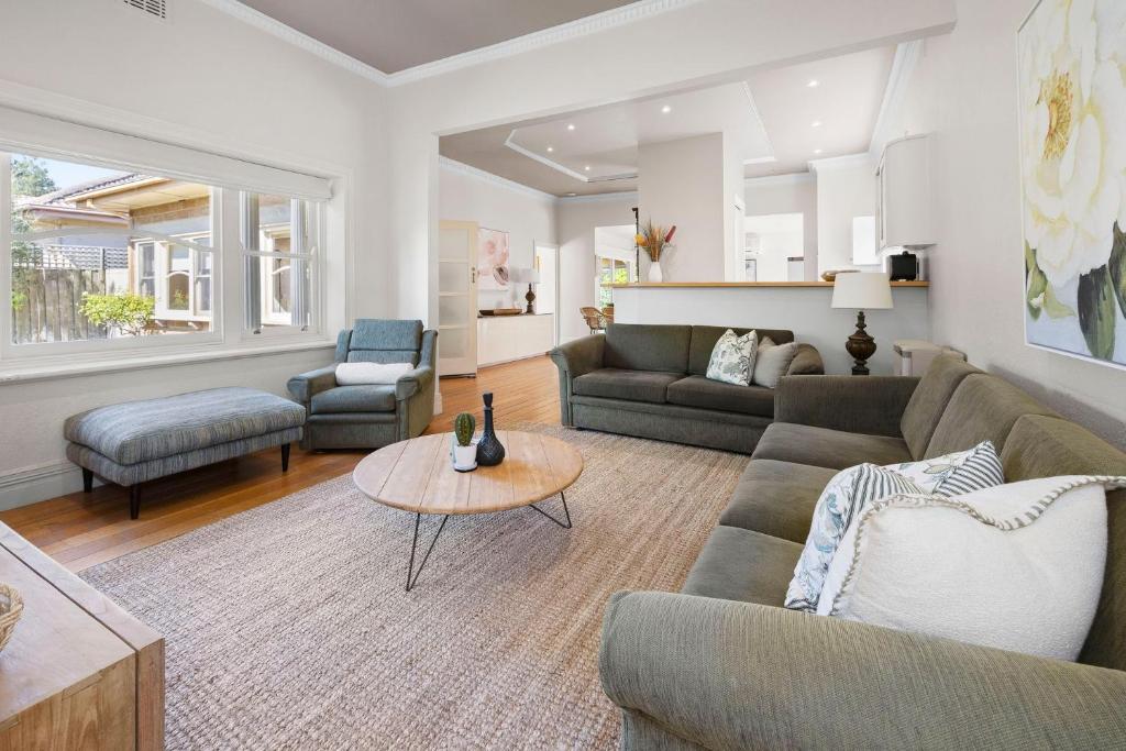 een woonkamer met een bank en een tafel bij Coral Rose Cottage in Capel Sound