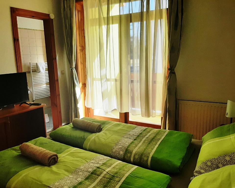 Postel nebo postele na pokoji v ubytování Szt Kristóf Bed and Breakfast