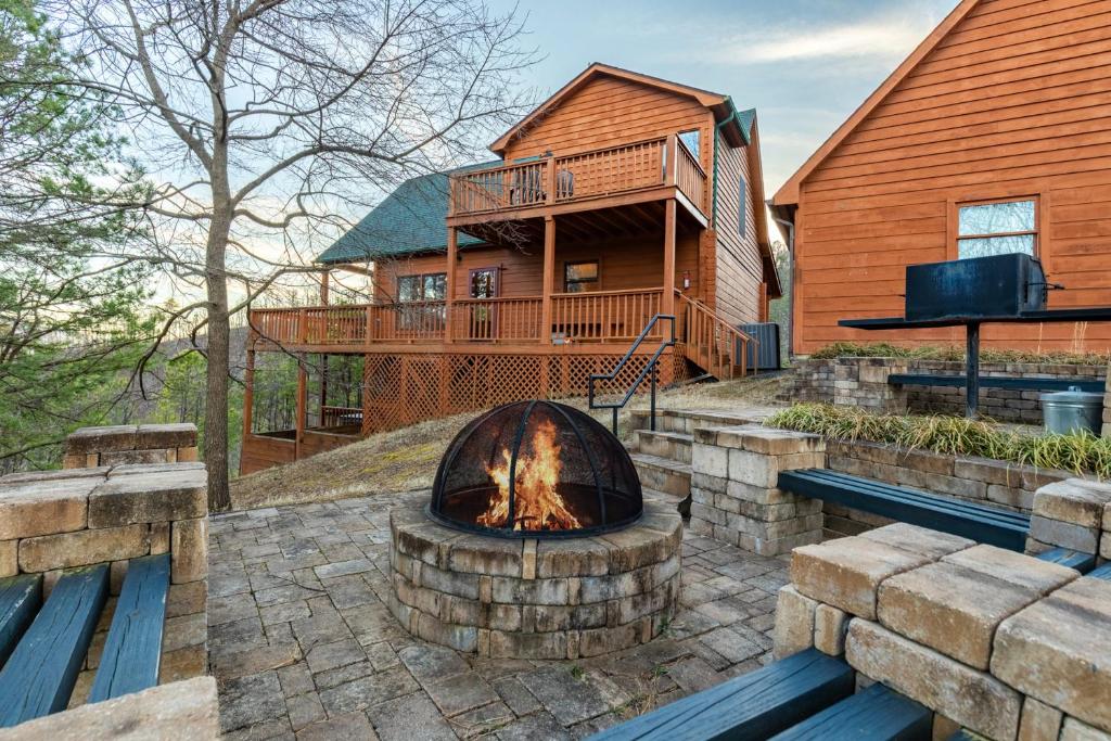 a fire pit in front of a wooden house at Smoky Overlook in Sevierville