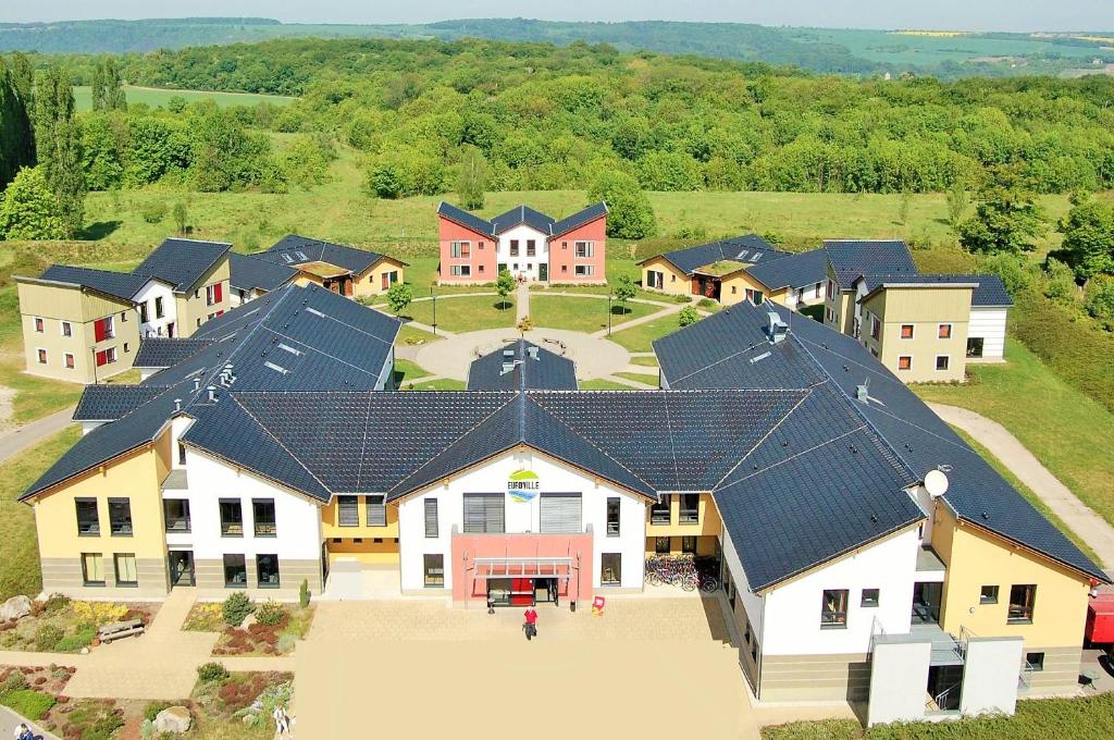 an aerial view of a large house with roofs at Euroville Jugend- und Sporthotel in Naumburg