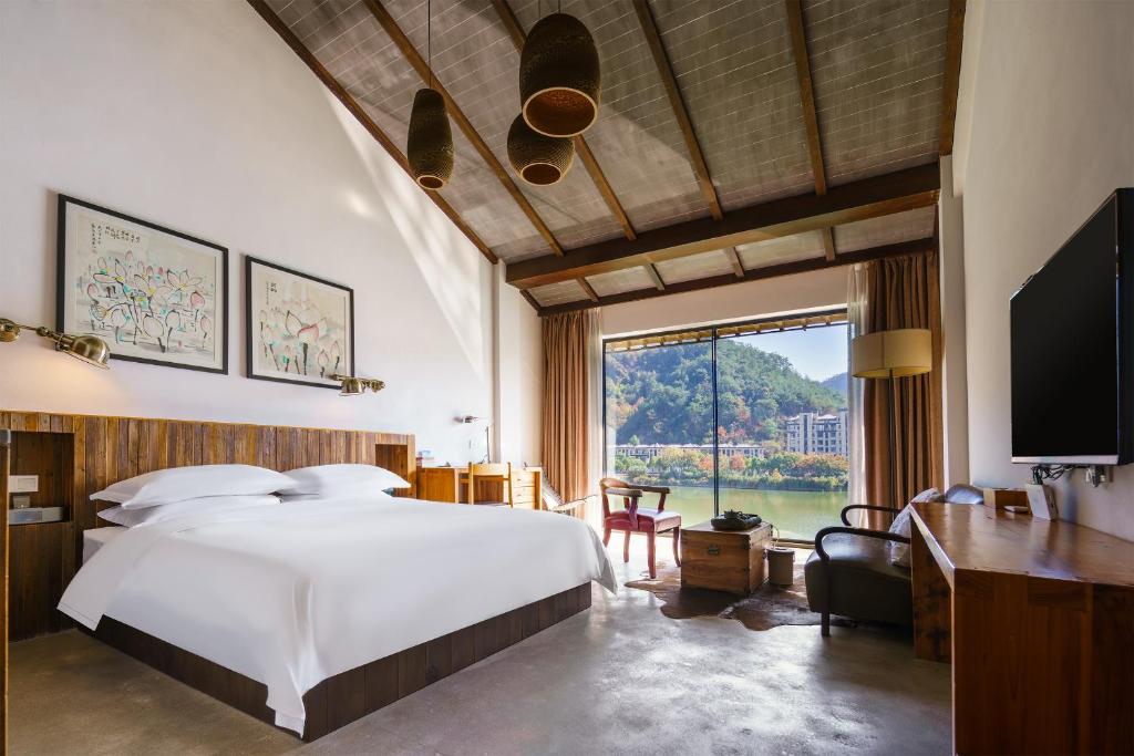 Postel nebo postele na pokoji v ubytování Huangshan Shanshuijian Wei Boutique Hotel