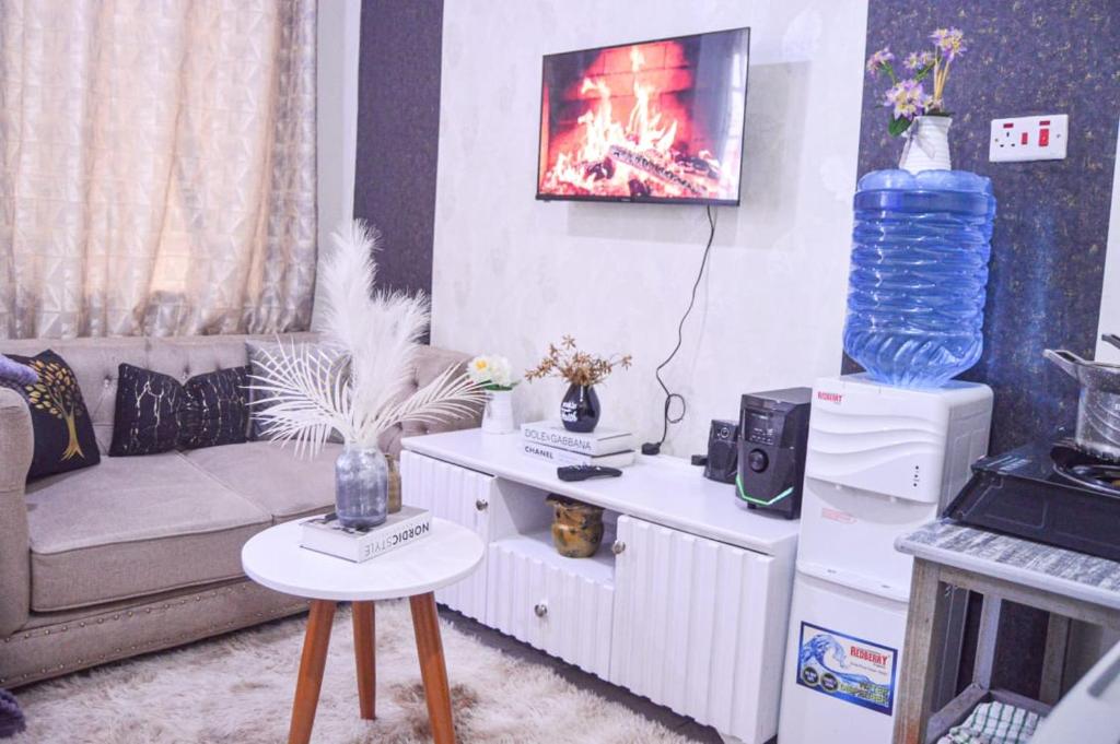 a living room with a couch and a table at Lux Suites L&N Apartments Utawala in Embakasi