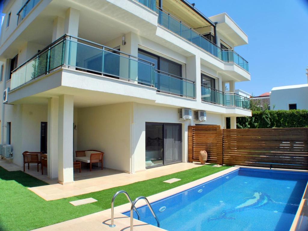 a house with a swimming pool in front of a house at Villa Sade in Bodrum City