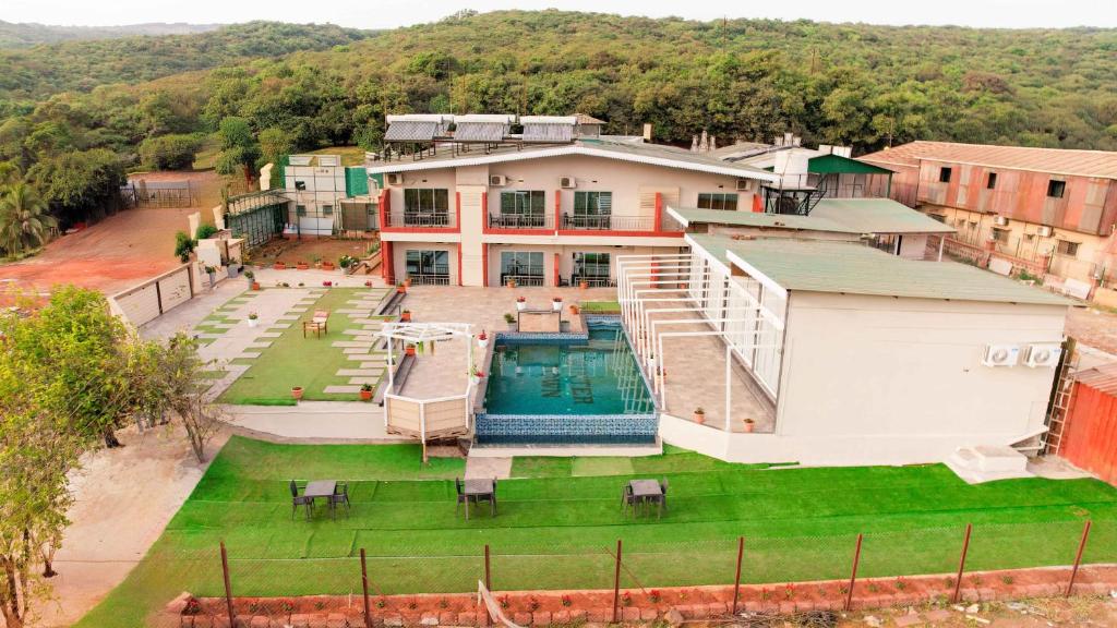 an aerial view of a house with a swimming pool at Treebo Winter Town Venna Lake with Swimming Pool in Mahabaleshwar
