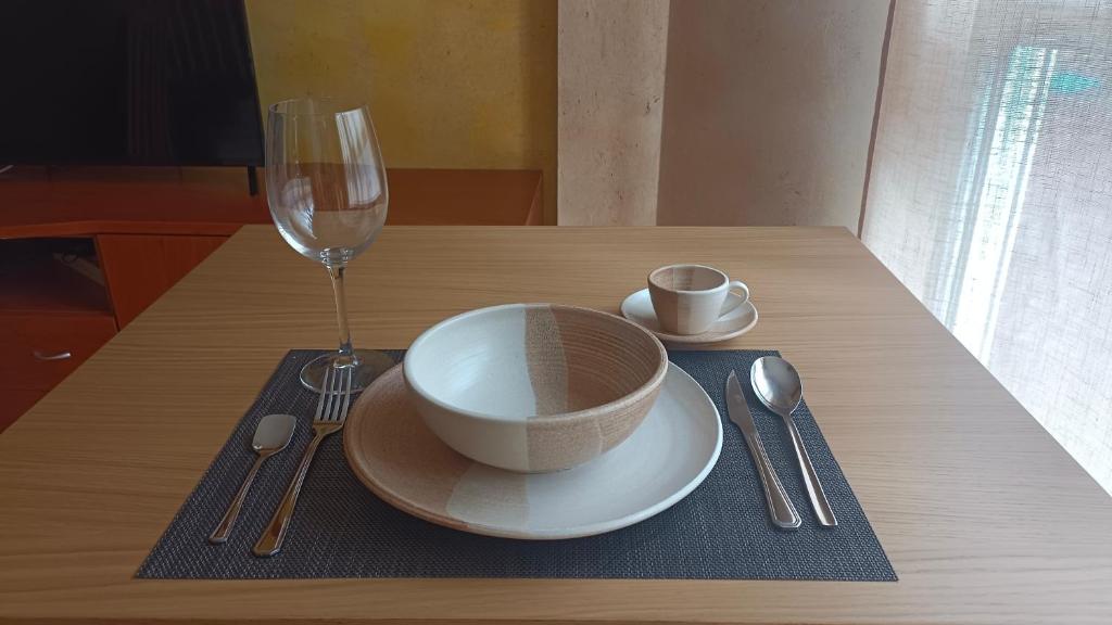 a table with a plate and a glass of wine at Casa el Alfar mudéjar in Teruel