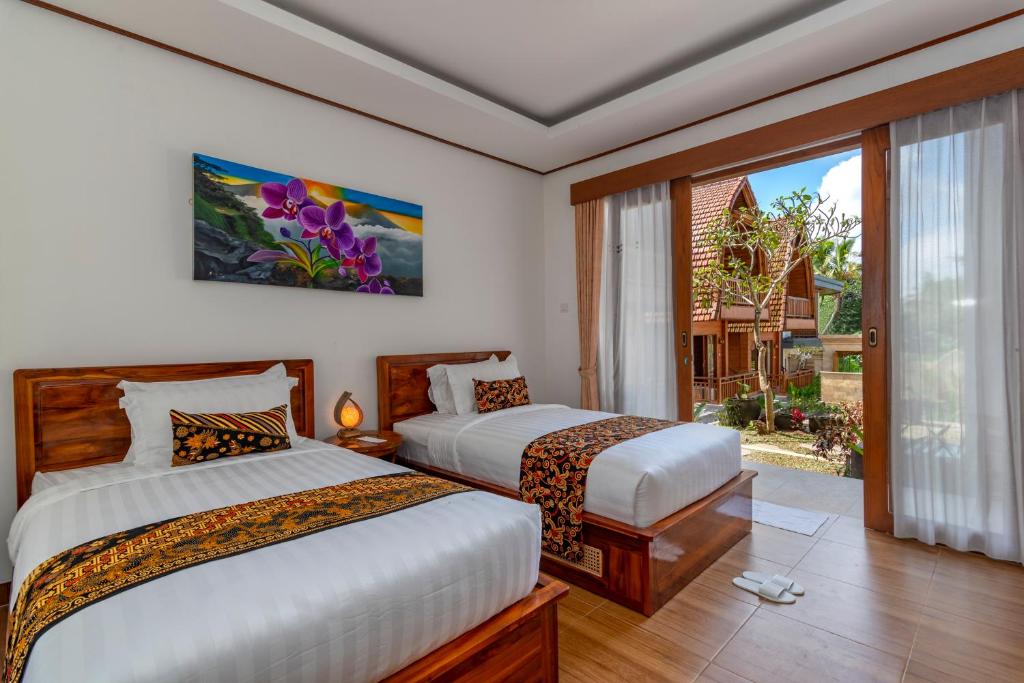 Postel nebo postele na pokoji v ubytování Uma Nandhi Villa Ubud