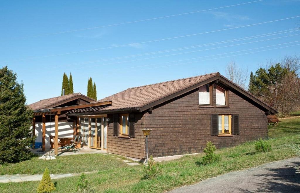 a small brick house with a roof at Ferienhaus Gamssteige im Feriendorf Reichenbach G13b in Nesselwang