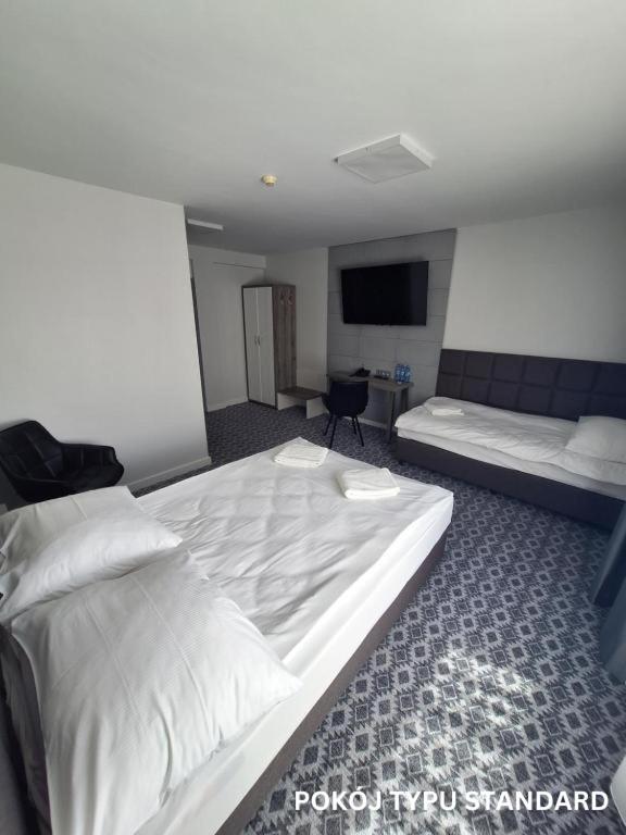 Łóżko lub łóżka w pokoju w obiekcie Hotel Gordon
