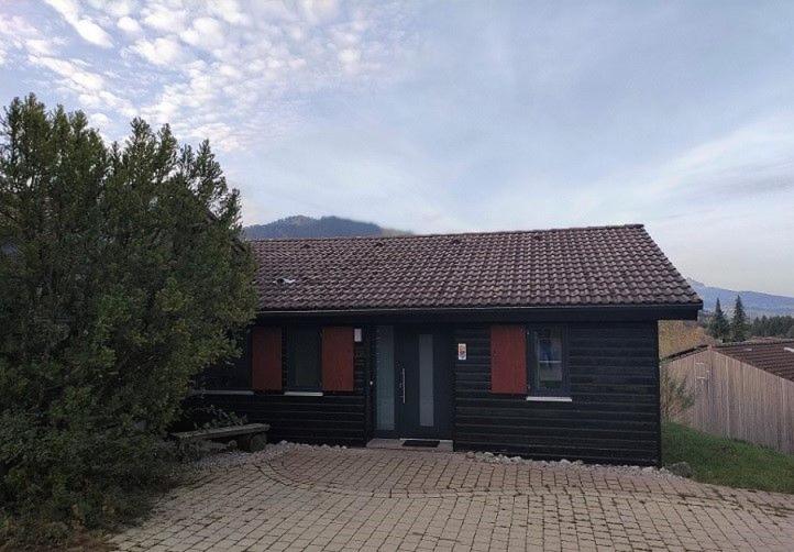 a small house with a brick driveway in front of it at Ferienhaus Gamssteige im Feriendorf Reichenbach G25b in Nesselwang