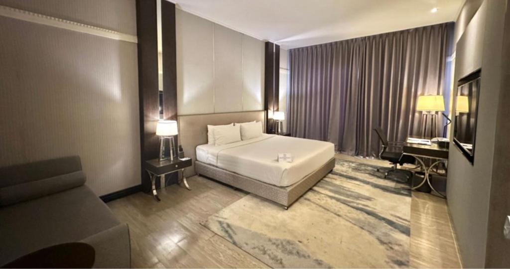 Postel nebo postele na pokoji v ubytování Le Charmé Suites - Subic
