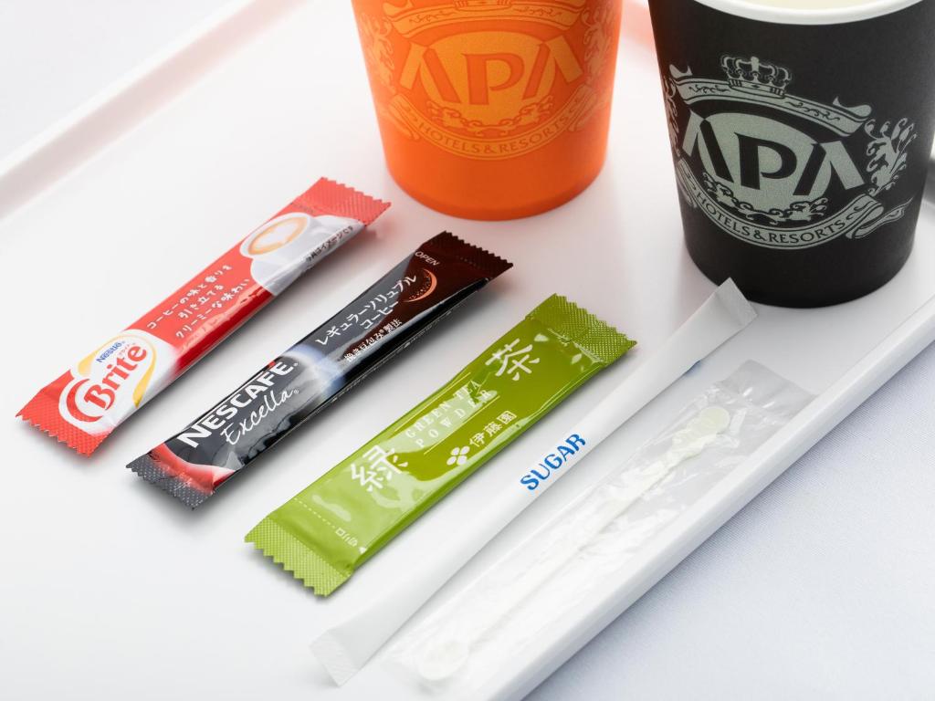 a group of toothbrushes and a bottle of soda at APA Hotel Shibuya Dogenzakaue in Tokyo