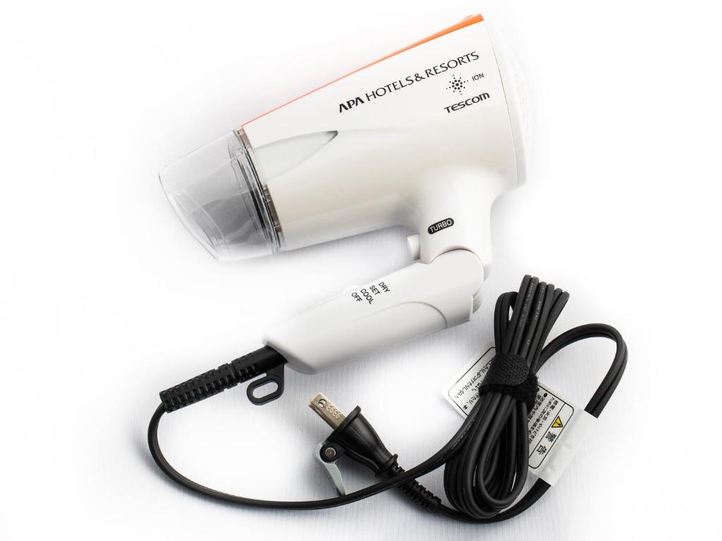 a hair dryer with a cord and a blow dryer at APA Hotel Shibuya Dogenzakaue in Tokyo