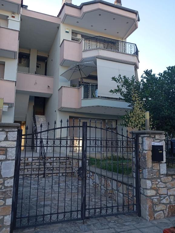 a building with an iron gate in front of it at Nea Peramos Breeze in Nea Peramos