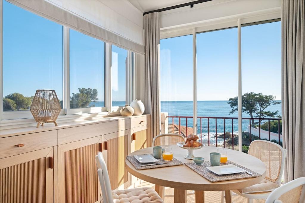 - une salle à manger avec une table et une vue sur l'océan dans l'établissement Le Duplex de la Mer, vue magnifique, accès plage, à Fréjus