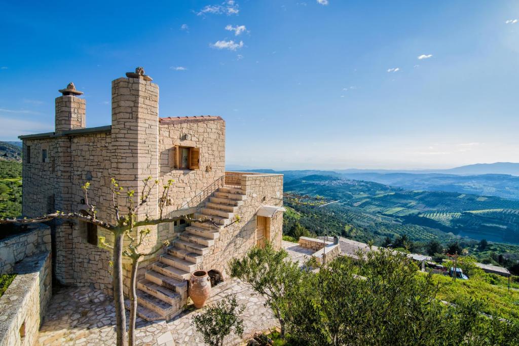 a stone house with stairs on the side of it at Panoramic View Villa in OliveGroves in Heraklio