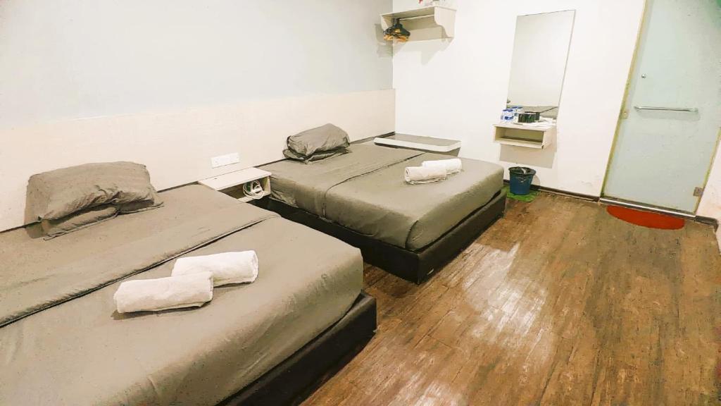Postel nebo postele na pokoji v ubytování Rg Hotel Ayer Hitam