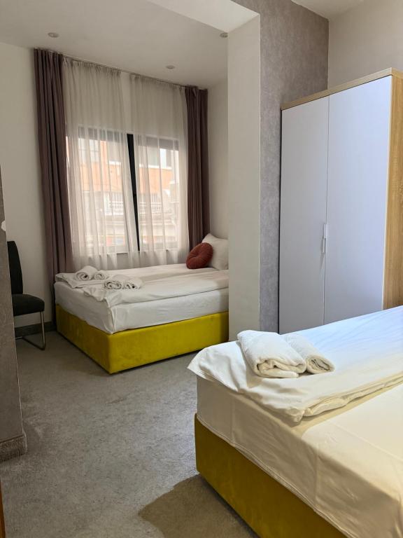 Postel nebo postele na pokoji v ubytování Deluxe Nortel Hotel