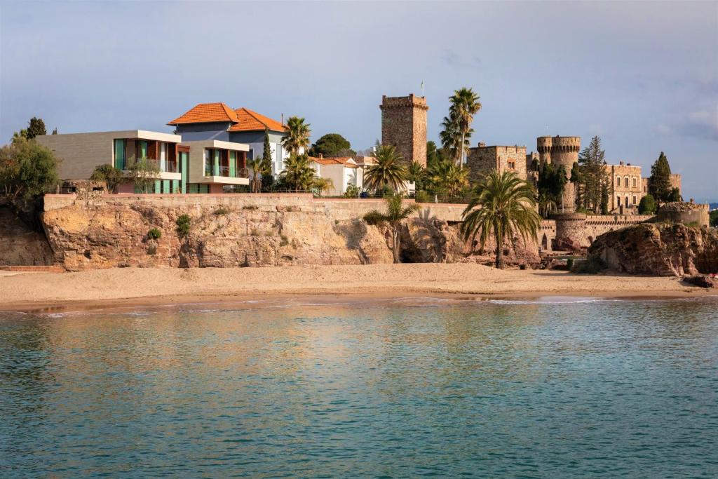 a house on the shore of a body of water at Villa Le Levant in Mandelieu-la-Napoule