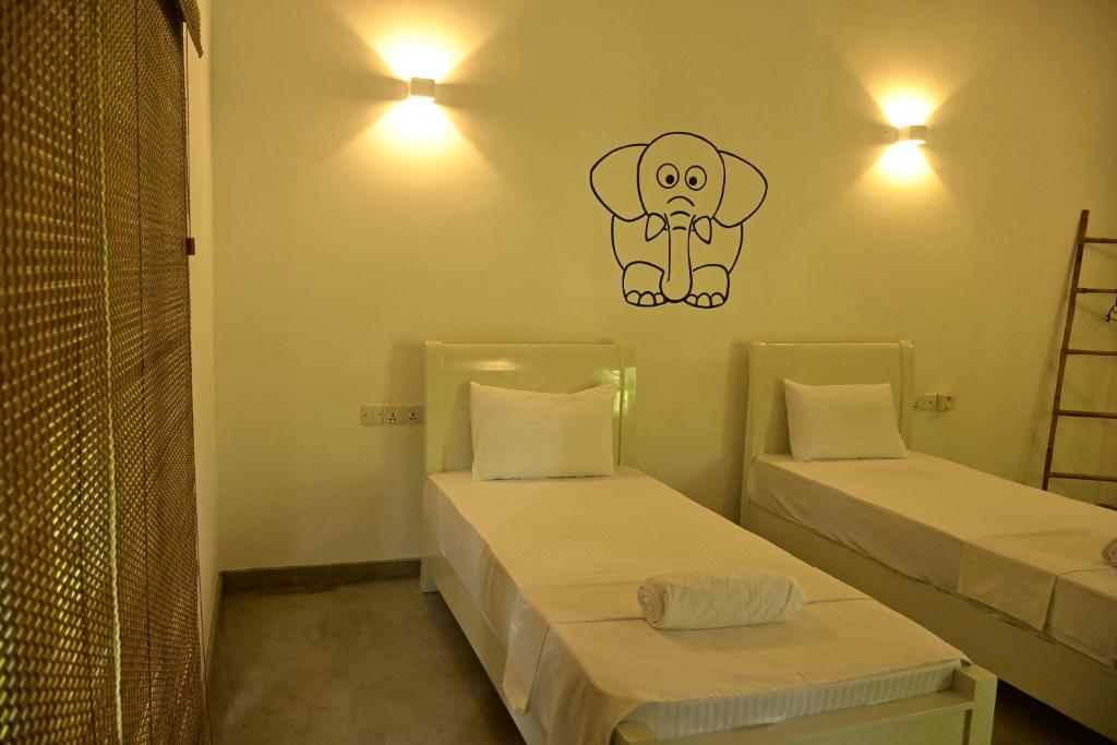 Postel nebo postele na pokoji v ubytování Moi Dambulla by DBI
