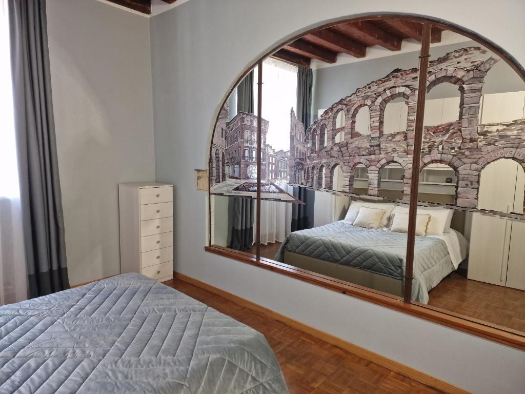 a bedroom with a mirror and a bed at Residence Via Duomo in Verona