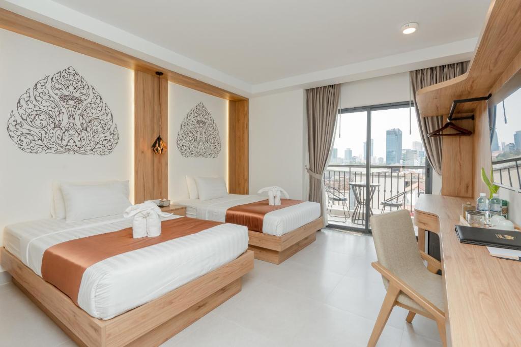 Postel nebo postele na pokoji v ubytování Botum Domrey Hotel