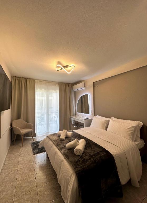 a bedroom with a large bed with a ceiling fan at 27 Urban Stay in Neochorópoulon