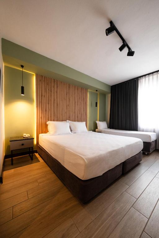 Postel nebo postele na pokoji v ubytování Polek Hotel