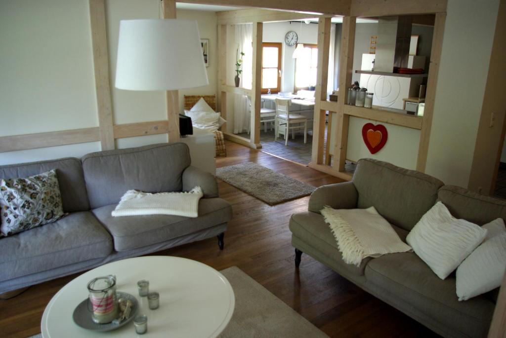 a living room with two couches and a table at Waldblick in Bleckede