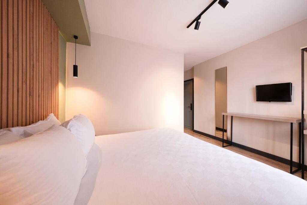 Postel nebo postele na pokoji v ubytování Polek Hotel