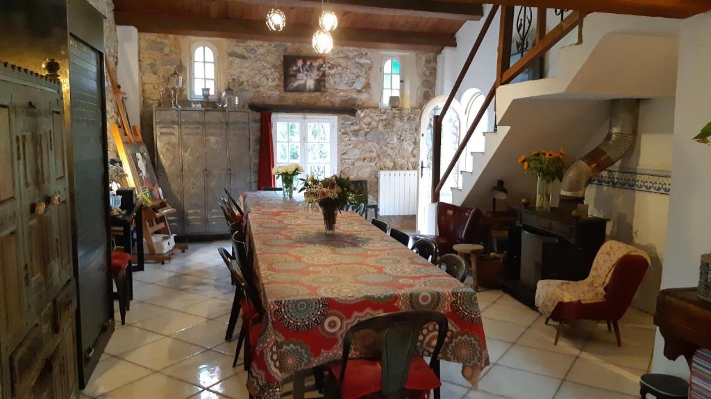 a dining room with a long table and chairs at Le Mas Nomade in Callian