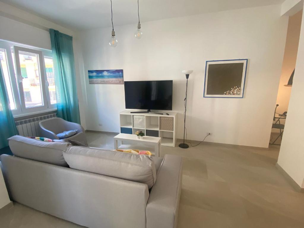 a living room with a couch and a flat screen tv at il posto giusto - the right place in Anzio