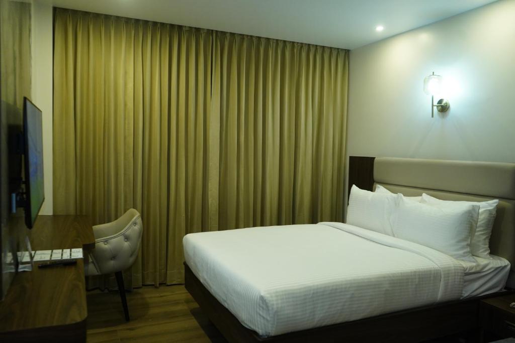 Postel nebo postele na pokoji v ubytování Jaag Hotel