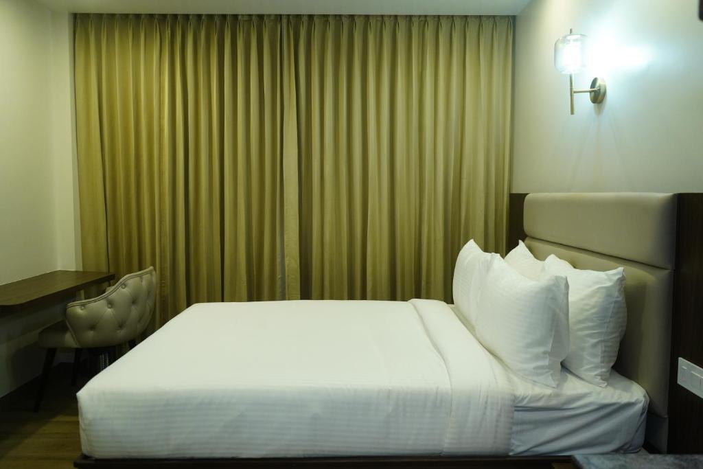 Postel nebo postele na pokoji v ubytování Jaag Hotel