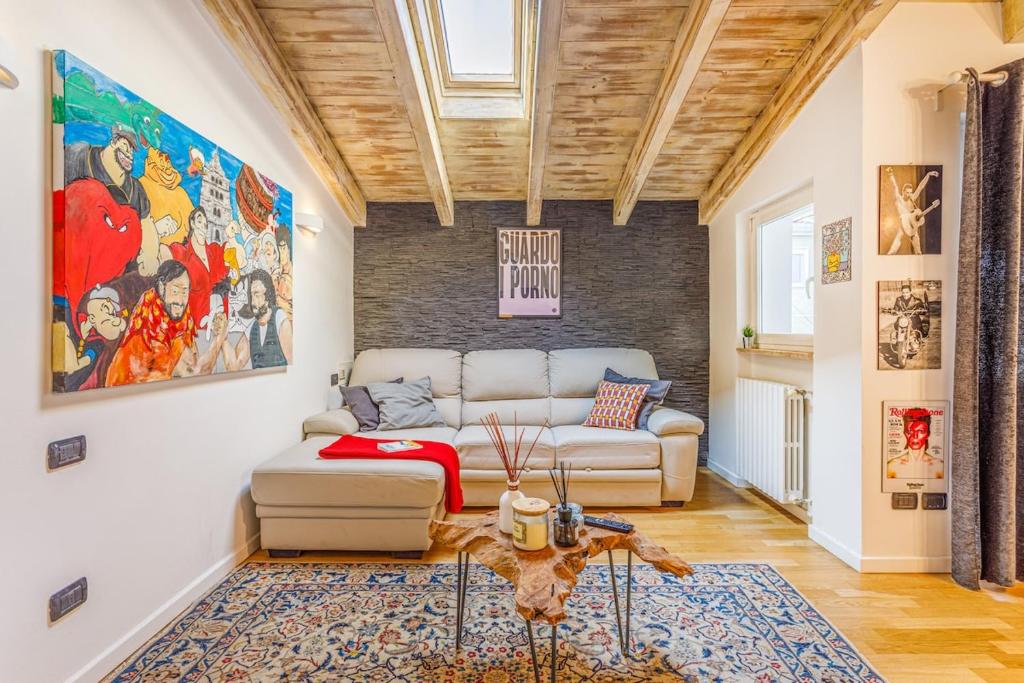 a living room with a couch and a table at Unconventional BnB near Linate - Supreme Meme Loft in Milan