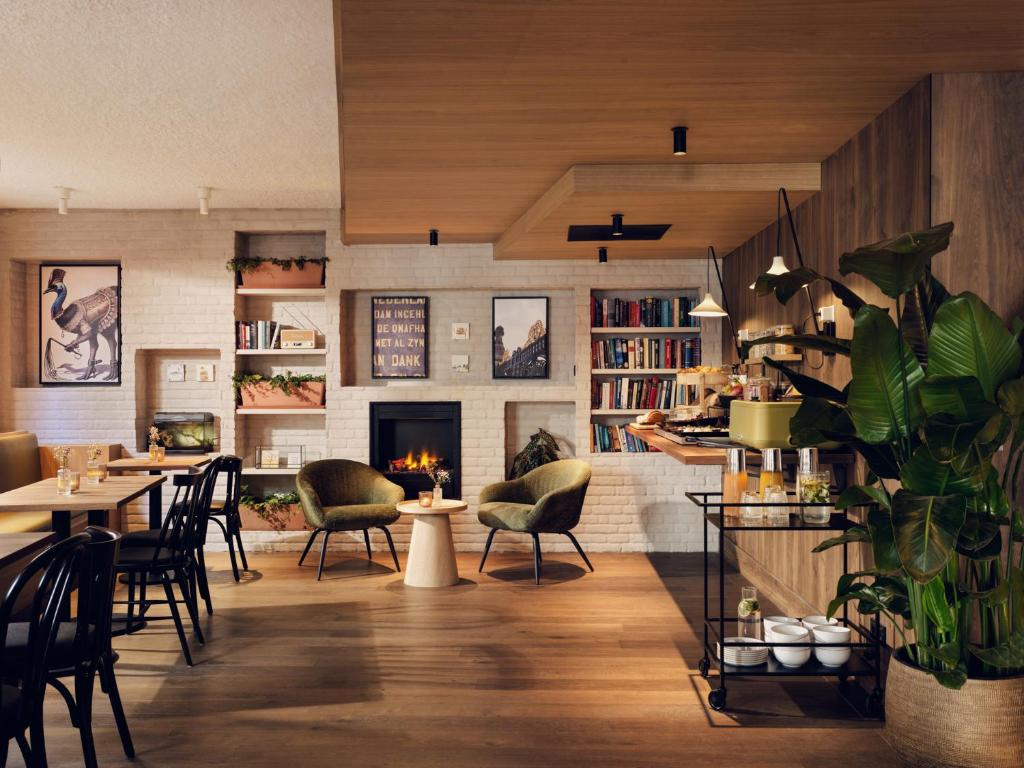 a restaurant with a fireplace and tables and chairs at Townhouse Den Haag in The Hague