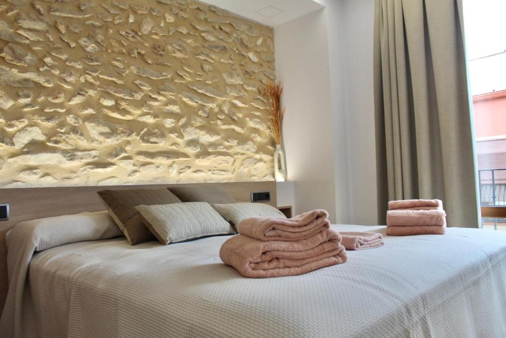 Postel nebo postele na pokoji v ubytování El Somni de Paqui Apartamentos Boutique Only Adults