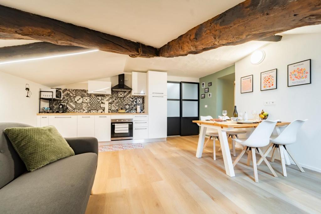 a kitchen and living room with a table and chairs at La Dimora di Barbaroux in Cuneo
