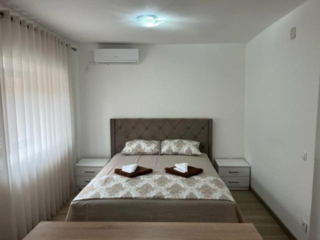 a bedroom with a bed with two trays on it at Apartment Stari Konak in Virpazar