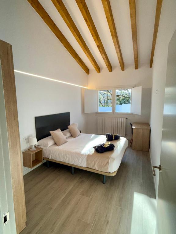 a bedroom with a large bed in a room at Apartamentos el puente in La Abadilla