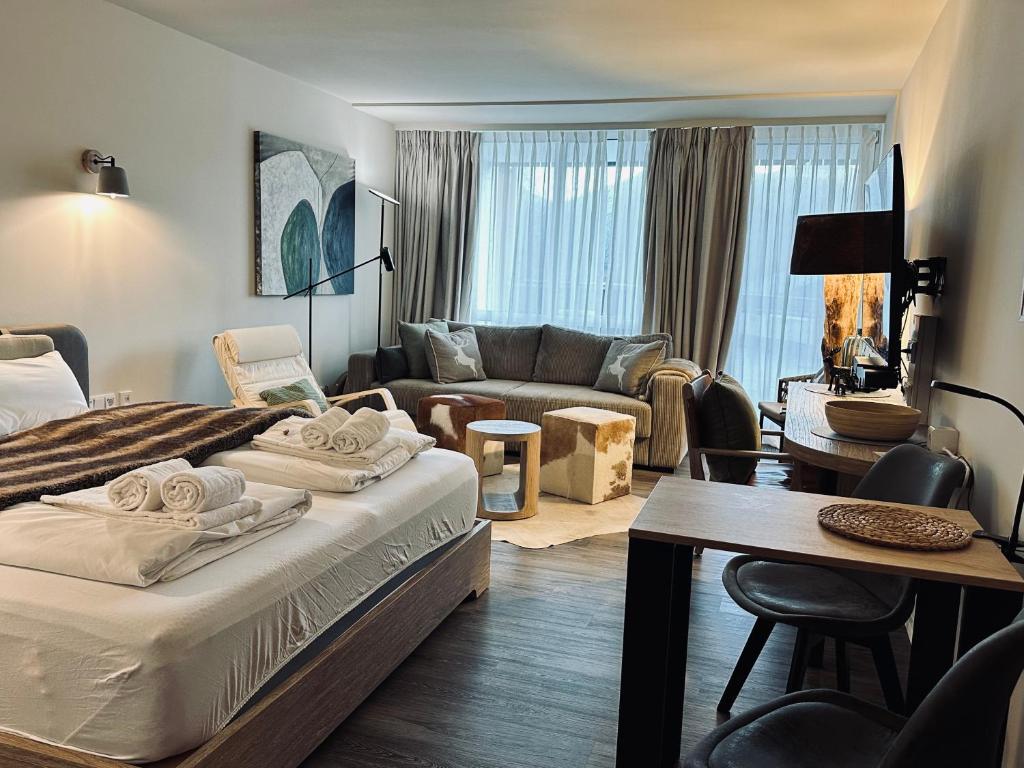 a bedroom with a bed and a living room at Apartment Schlierseeperle in Schliersee