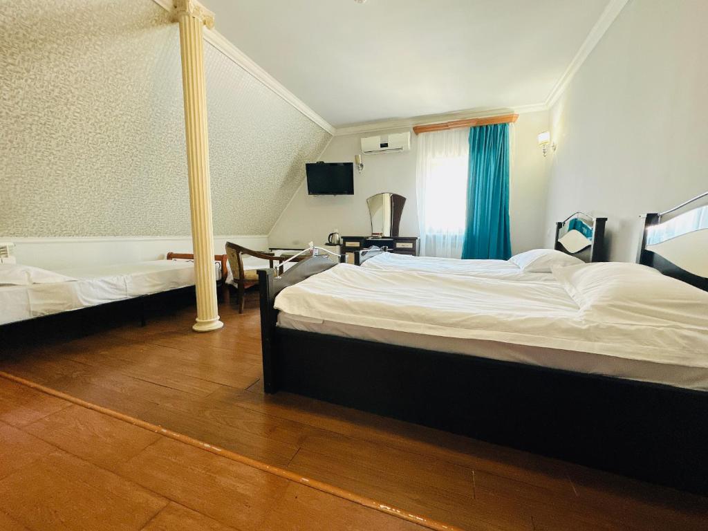 Postel nebo postele na pokoji v ubytování SD Hotel