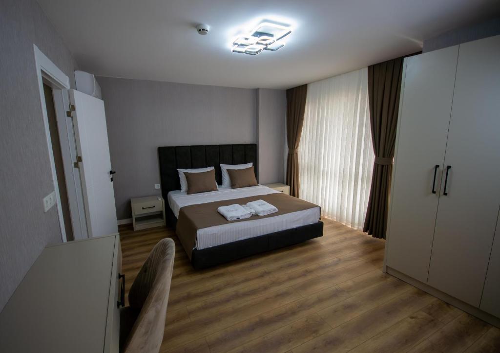 a bedroom with a bed and a chair in it at Luxury Life Suites in Istanbul