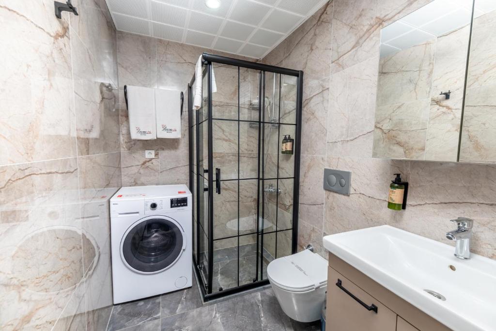 a bathroom with a washing machine and a sink at Luxury Life Suites in Istanbul