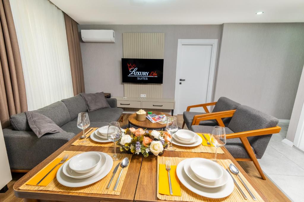 a living room with a table with plates and glasses at Luxury Life Suites in Istanbul