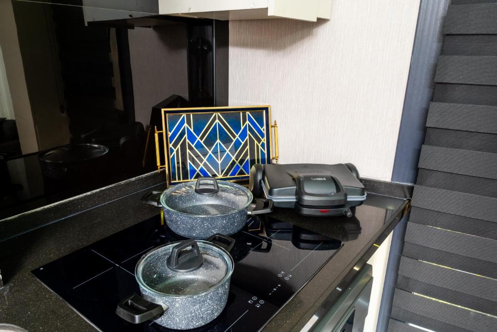 two pots and pans on a stove in a kitchen at Luxury Life Suites in Istanbul