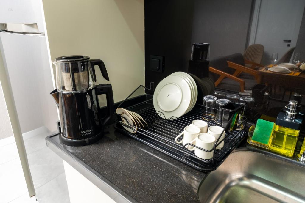 a kitchen counter with a coffee maker on a drying rack at Luxury Life Suites in Istanbul