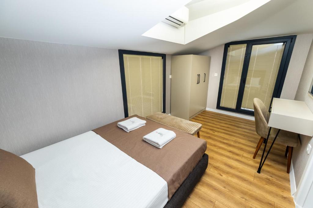 a bedroom with a bed and a desk in a room at Luxury Life Suites in Istanbul