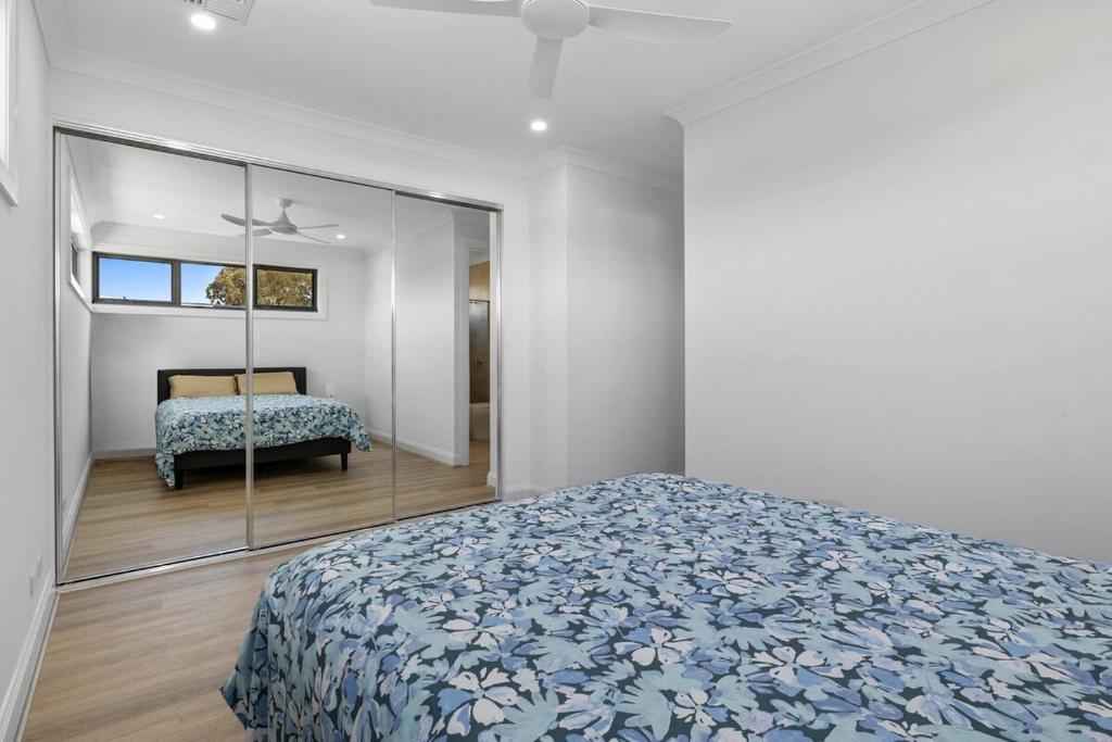 a bedroom with a bed and a mirror at Prospect High Street House in Prospect